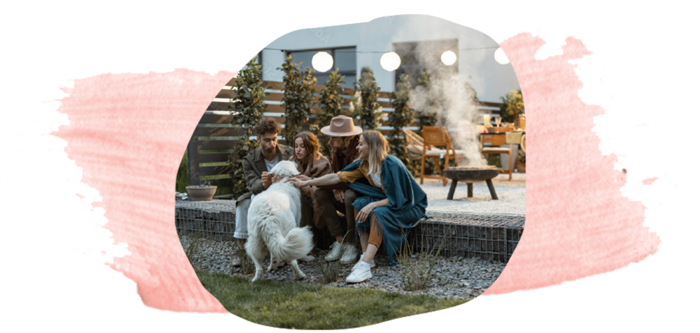 In the heart of Peoria, AZ, a group gathers around a cozy fire pit. Laughter fills the air as they interact with a large white dog, savoring the serene backdrop that new homes in Saddleback provide.